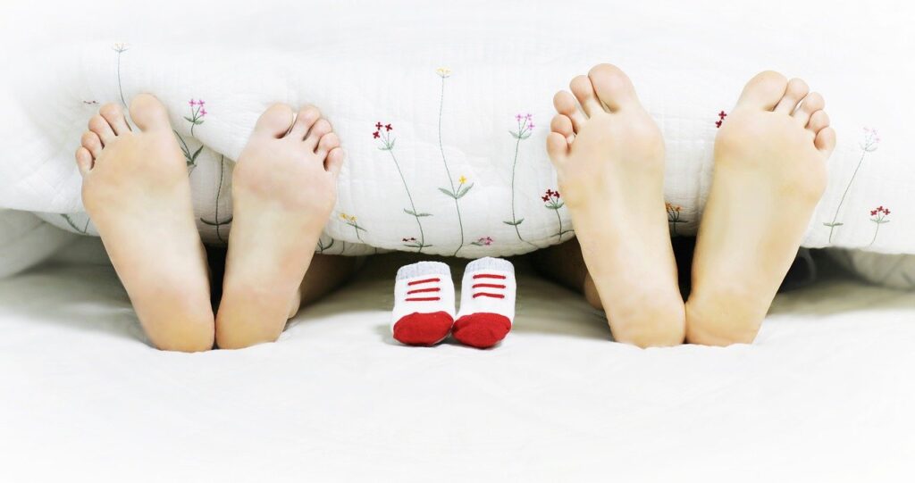 picture of a couple's feet and a baby's shoes