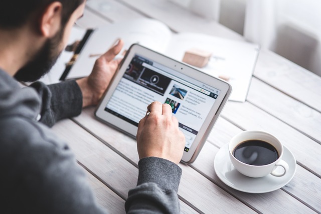 man reading on tablet
