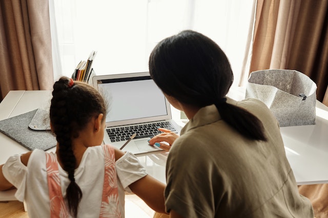 mother helping child study