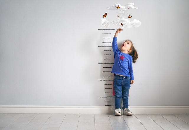 child measuring her height