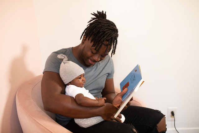 father reading to baby