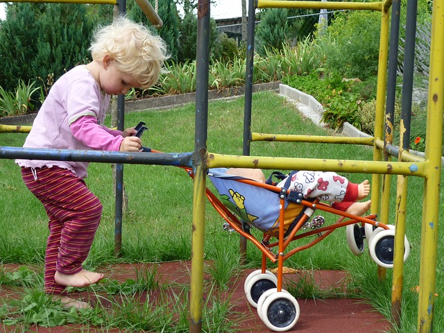 girl playing with doll pram