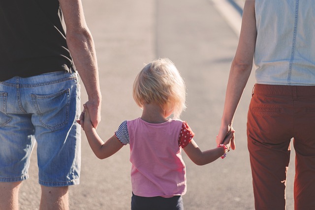 child holding parents' hands