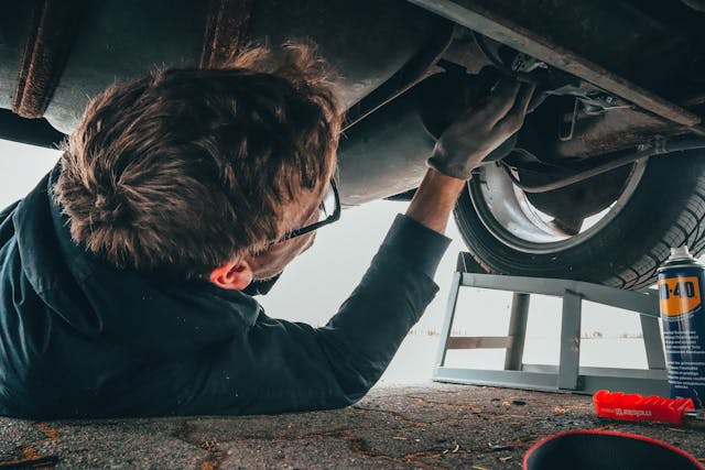 man fixing car