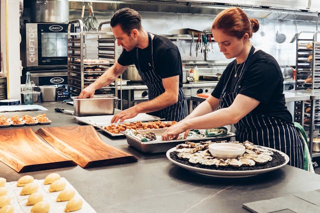 man and woman cooking in a kitchen